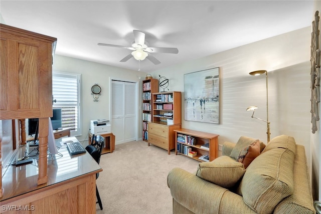 office space featuring light colored carpet and ceiling fan