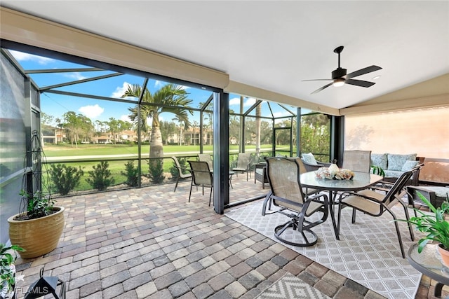 sunroom / solarium featuring ceiling fan and vaulted ceiling