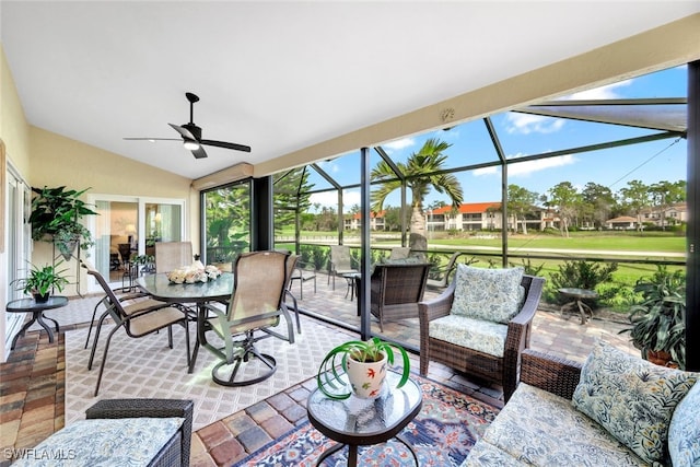 sunroom with ceiling fan and lofted ceiling