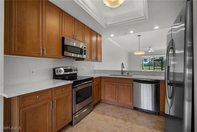 kitchen with stainless steel appliances, a raised ceiling, ceiling fan, sink, and pendant lighting