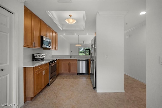 kitchen with ornamental molding, stainless steel appliances, a raised ceiling, sink, and decorative light fixtures