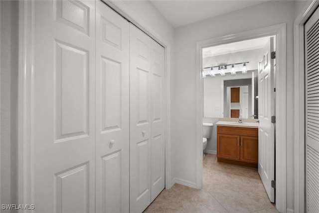 bathroom with tile patterned floors, vanity, and toilet