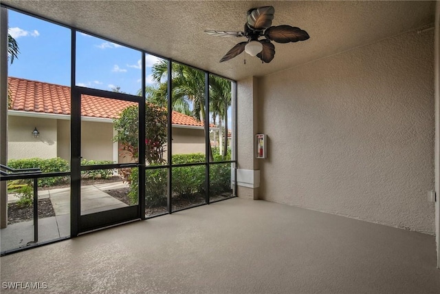 unfurnished sunroom featuring a wealth of natural light and ceiling fan