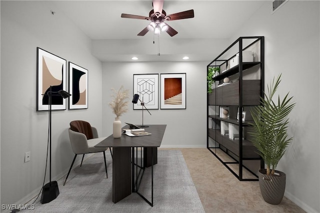 carpeted home office with ceiling fan