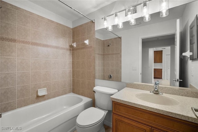 full bathroom with vanity, tiled shower / bath combo, and toilet