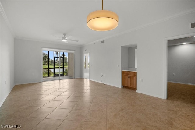 empty room featuring light tile patterned floors, ceiling fan, and crown molding