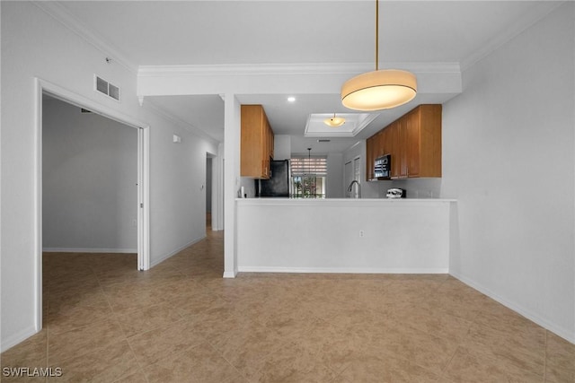 kitchen featuring fridge, crown molding, decorative light fixtures, and sink