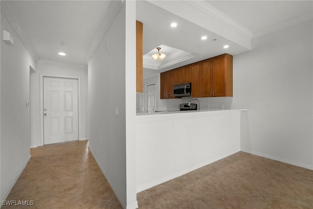 kitchen with kitchen peninsula, light tile patterned floors, and ornamental molding