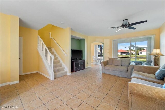 unfurnished living room featuring ceiling fan and light tile patterned flooring