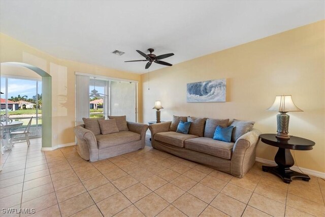 living room with ceiling fan and light tile patterned floors