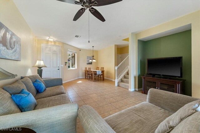 living room featuring ceiling fan and light tile patterned floors