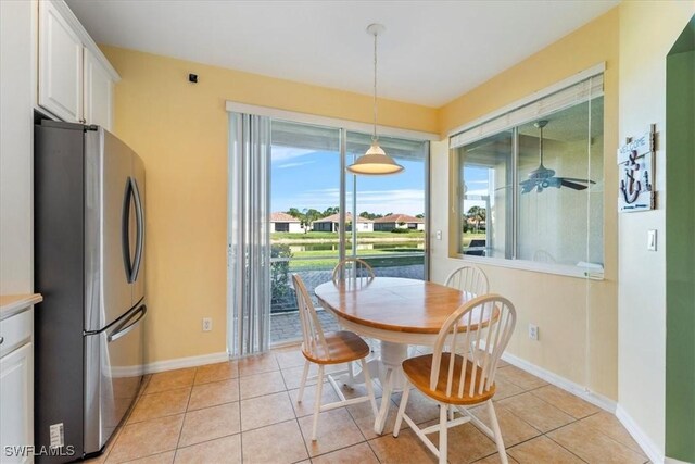 tiled dining room featuring ceiling fan and a wealth of natural light