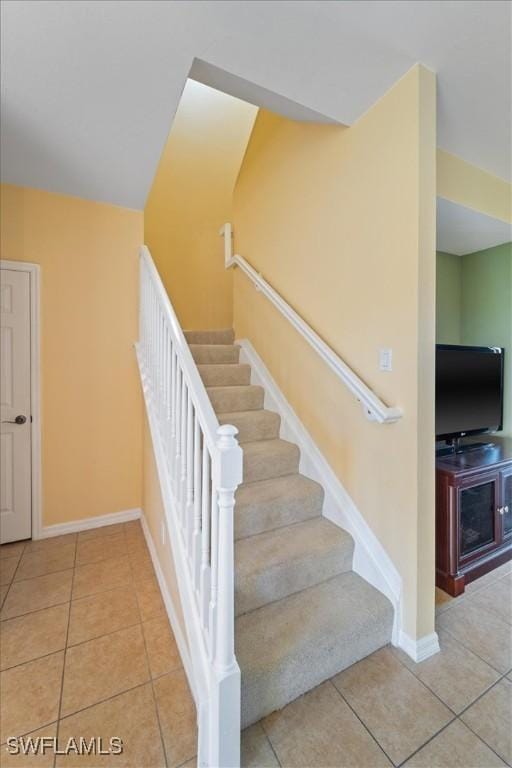 stairway with tile patterned floors