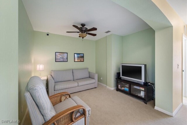 living room with light carpet and ceiling fan