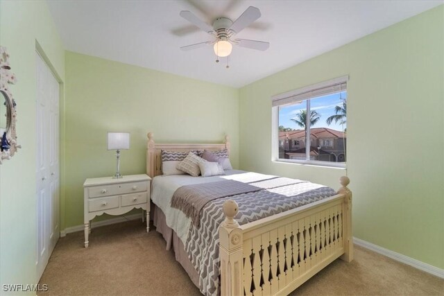 carpeted bedroom with ceiling fan and a closet