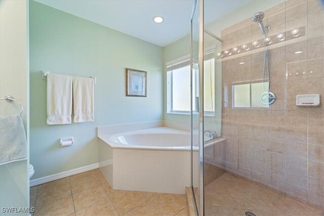 bathroom with tile patterned floors, toilet, and shower with separate bathtub