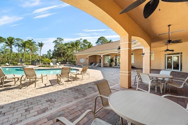 view of patio featuring ceiling fan and a community pool