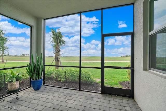 unfurnished sunroom with a rural view