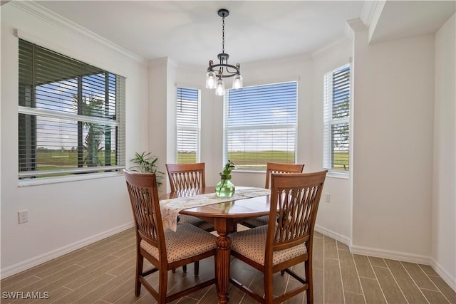 dining room with hardwood / wood-style floors, a notable chandelier, and crown molding