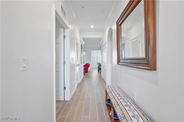 hallway featuring crown molding and light wood-type flooring