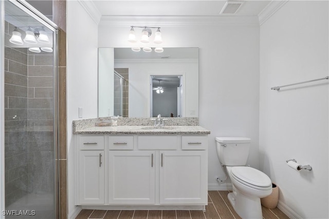 bathroom with vanity, toilet, walk in shower, and crown molding