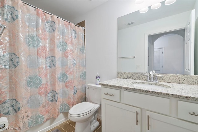 bathroom featuring tile patterned floors, vanity, and toilet