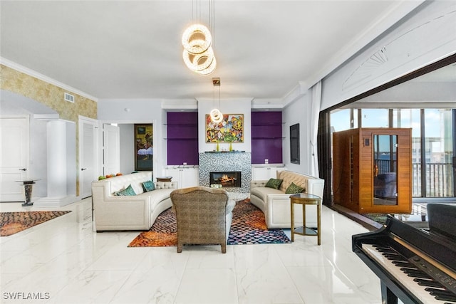 living room featuring ornamental molding and a tiled fireplace