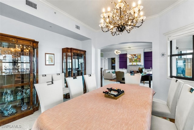 dining area with ornamental molding and an inviting chandelier