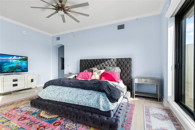 bedroom with ceiling fan, light hardwood / wood-style flooring, and ornamental molding