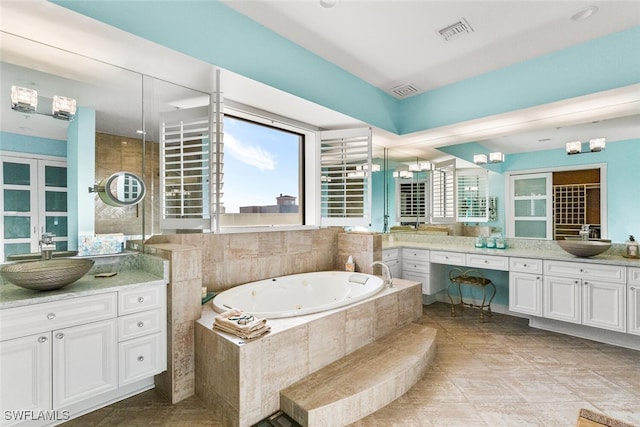 bathroom with vanity and a relaxing tiled tub