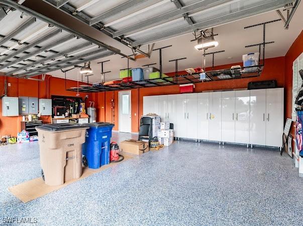 garage featuring a garage door opener and electric panel