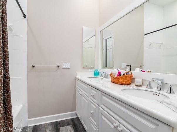 bathroom featuring vanity, shower / bath combo with shower curtain, and hardwood / wood-style floors