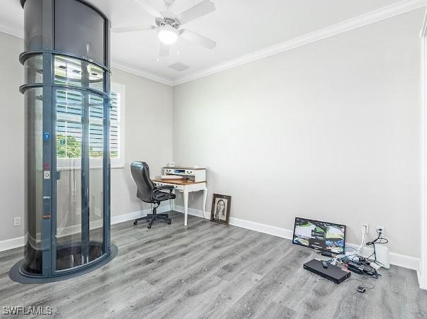 home office featuring ceiling fan, wood-type flooring, and crown molding