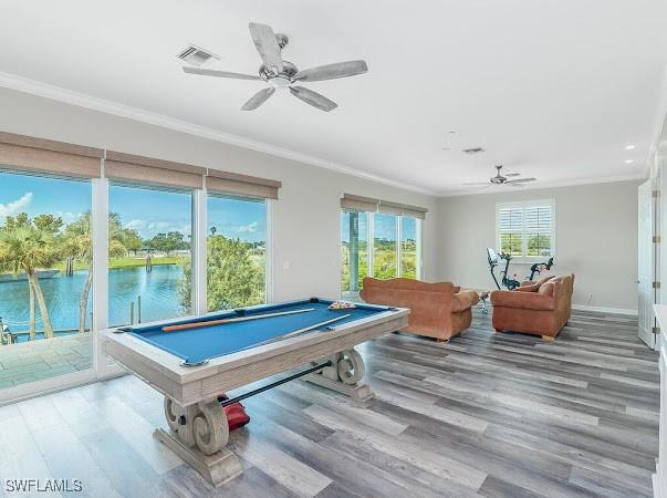 rec room with a water view, billiards, crown molding, and hardwood / wood-style flooring