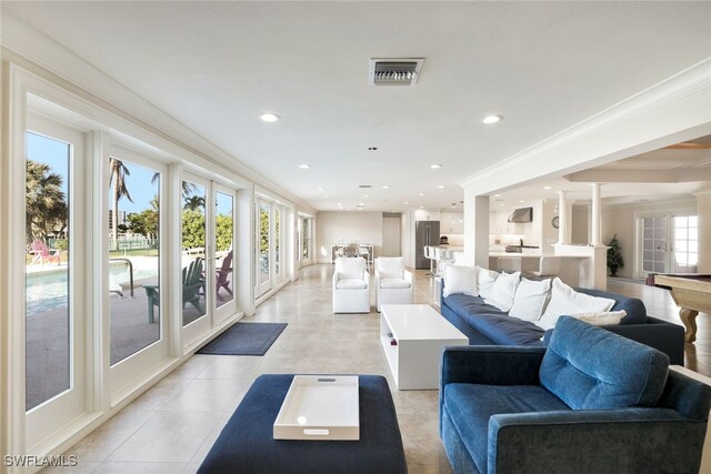 living area with french doors, crown molding, decorative columns, recessed lighting, and visible vents