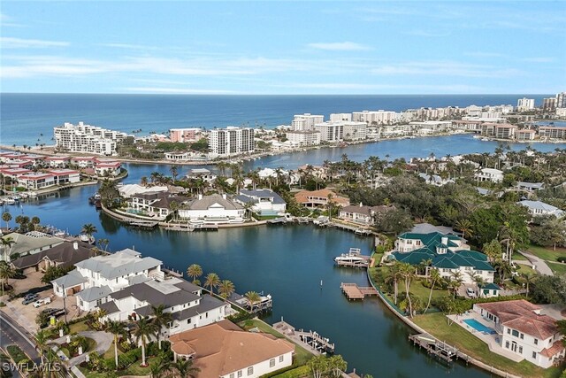 birds eye view of property featuring a view of city and a water view