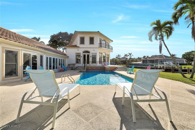 outdoor pool featuring french doors and a patio area