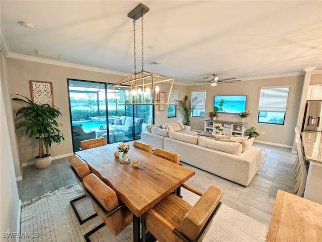 dining room featuring ceiling fan with notable chandelier and crown molding