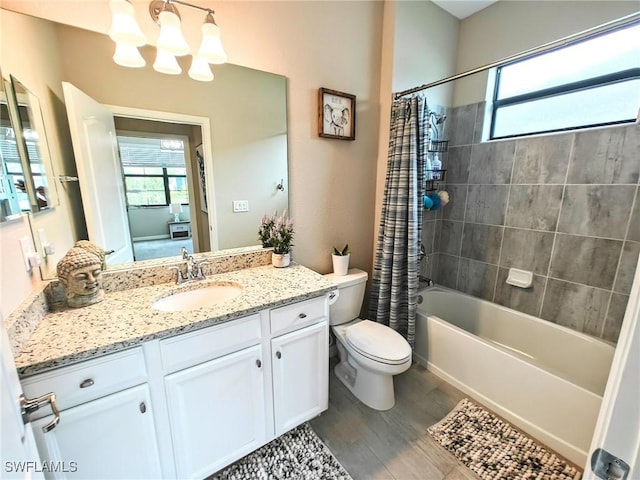 full bathroom with vanity, shower / tub combo with curtain, wood-type flooring, an inviting chandelier, and toilet