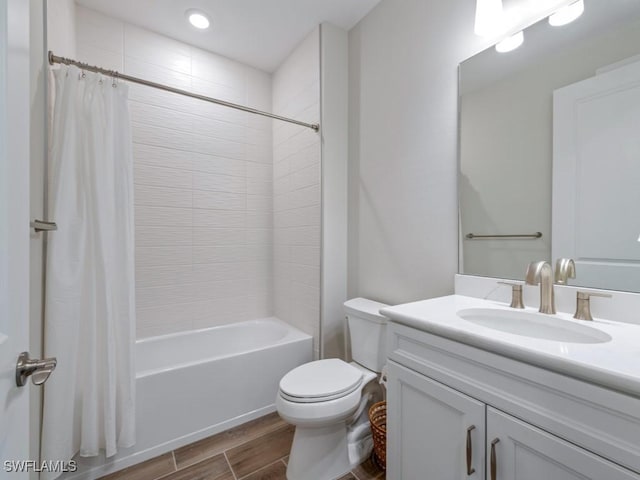 full bathroom featuring shower / bath combo with shower curtain, vanity, and toilet