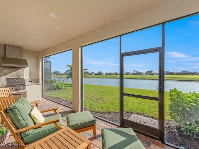 sunroom with a water view and a wealth of natural light