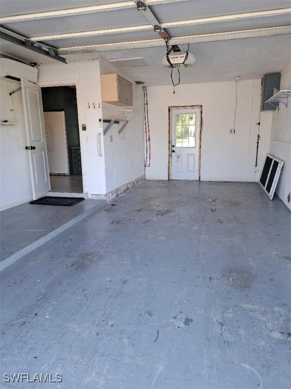 garage featuring white fridge and a garage door opener