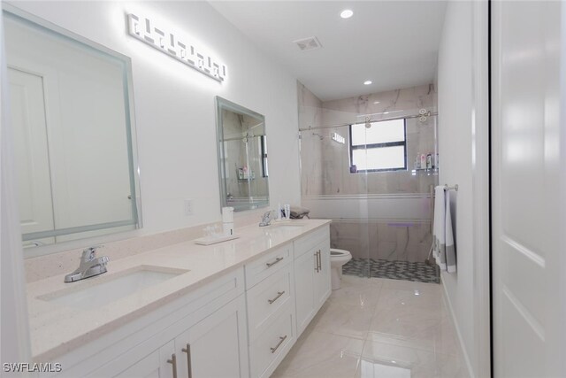 full bathroom with vanity, toilet, and bath / shower combo with glass door