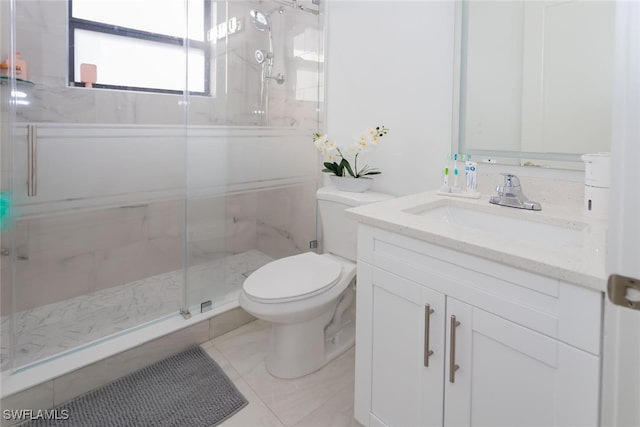 bathroom with tile patterned floors, vanity, an enclosed shower, and toilet