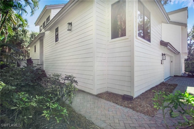 view of side of home featuring a garage