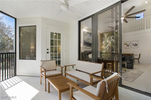 sunroom / solarium featuring ceiling fan