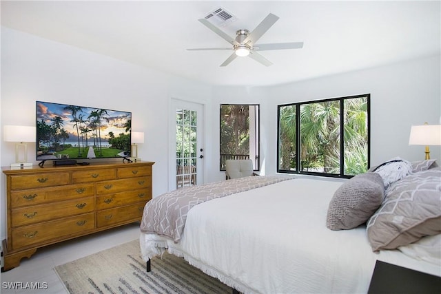 bedroom with multiple windows, access to outside, and ceiling fan