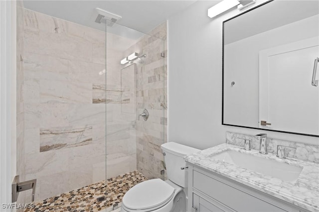 bathroom featuring toilet, a stall shower, visible vents, and vanity