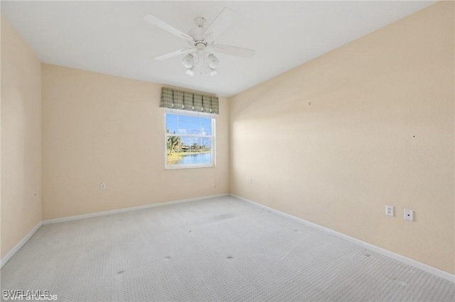 empty room with ceiling fan and light carpet