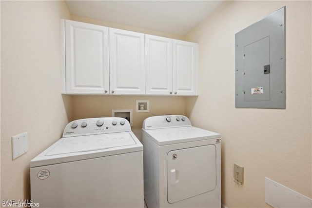 laundry room featuring cabinets, electric panel, and washer and clothes dryer